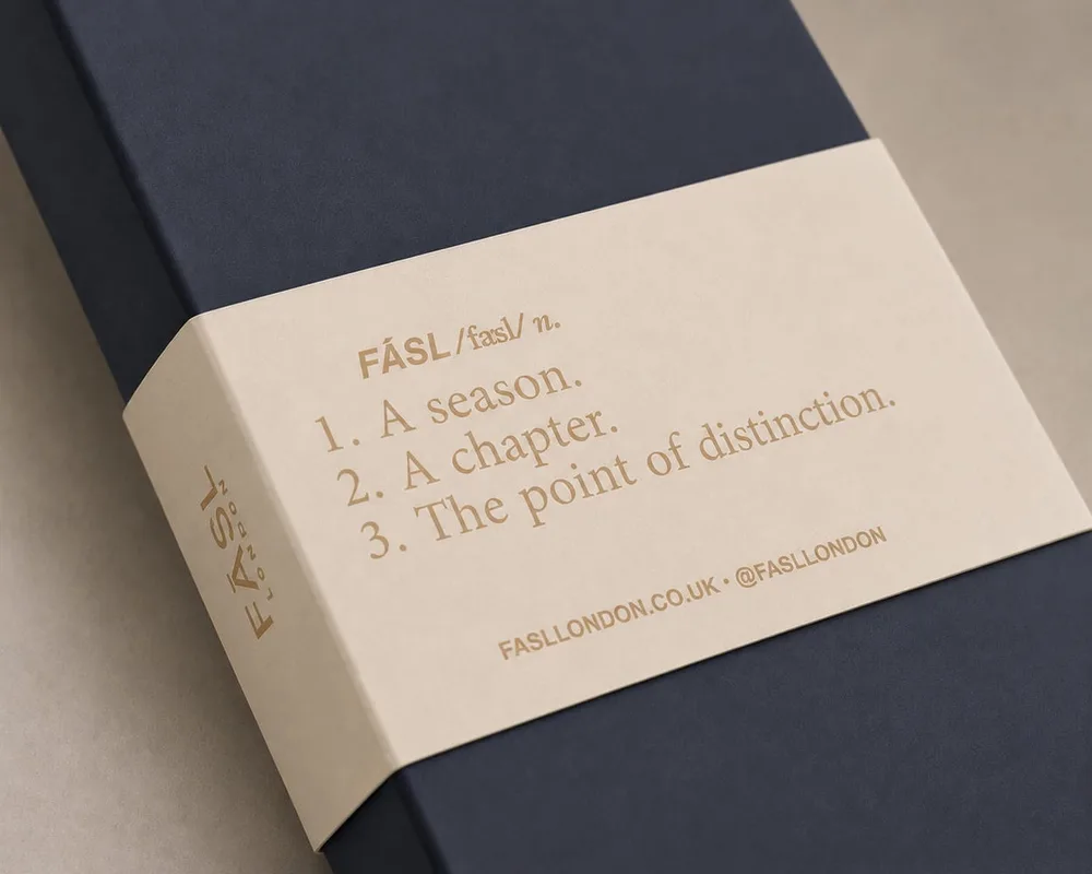 The FĀSL presentation box with a cream sleeve printed with the word's definition: a season, a chapter, the point of distinction